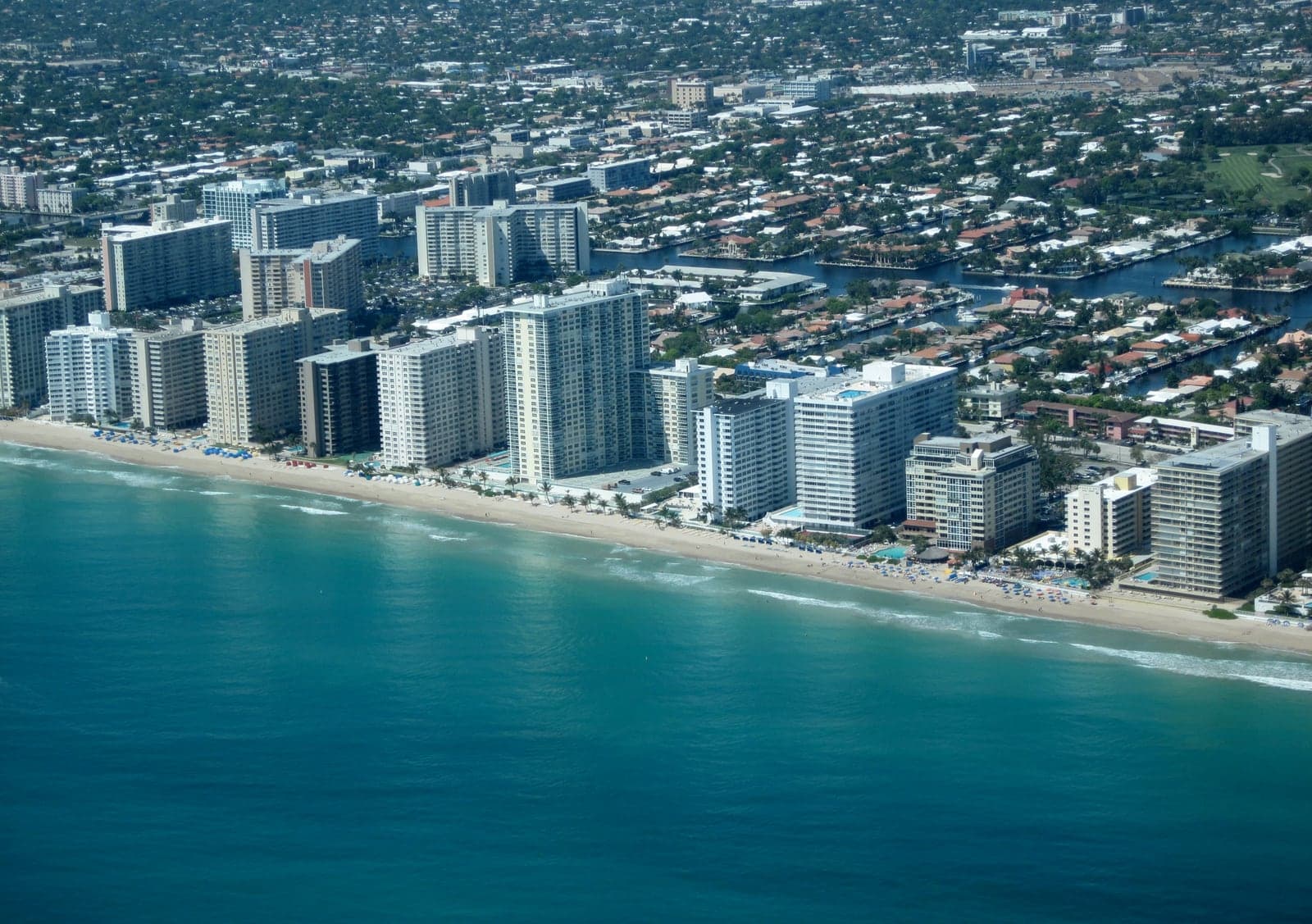 Aerial view of oceanfront residential towers along a barrier island
